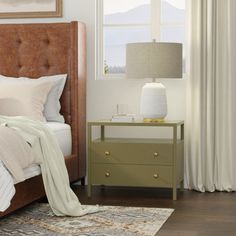 a bedroom scene with focus on the bed, nightstands and window curtained drapes