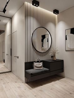 a black and white living room with a round mirror on the wall