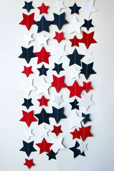 red, white and blue stars are hanging on the wall