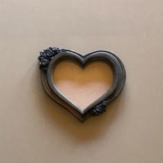 a heart shaped mirror hanging on the wall