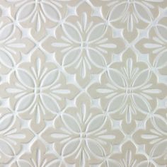 a close up view of the white flower pattern on a wallpapered surface,