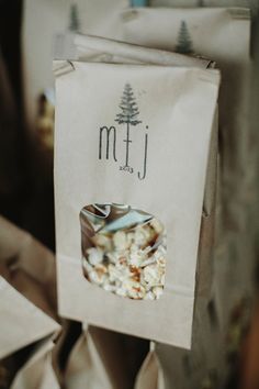 a paper bag filled with popcorn sitting on top of a pile of brown paper bags