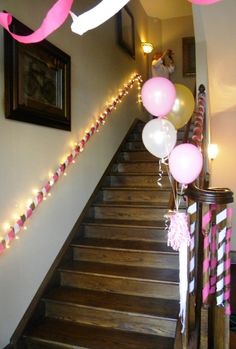 some balloons and streamers are on the stairs