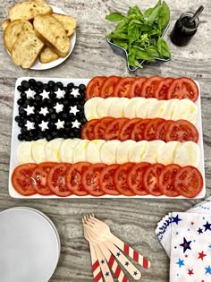 an american flag platter with tomatoes, olives and crackers