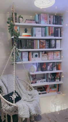 a white chair sitting in front of a book shelf filled with lots of books on top of it