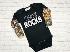 One Rocks 1st Birthday Shirt Celebrating that special first birthday! Your little One will show his personality in our tattoo sleeve Birthday shirt. Custom made for your little rock star baby boy. Great for those cake smash pictures. A truly unique birthday shirt Note: 0-3 months up to 12-18 Month will be a bodysuit 2T will be a T-Shirt Visit Shop https://www.etsy.com/shop/sassylocks Rock Star First Birthday, One Rocks First Birthday Smash Cake, One Year Old Rock And Roll Birthday, Punk Rock First Birthday, Unique First Birthday, Rockstar First Birthday, First Birthday Rock N Roll, Rock First Birthday, One Rocks First Birthday