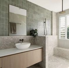 a bathroom with a sink, mirror and bathtub