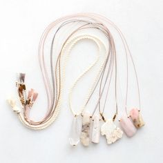 four necklaces with different shapes and colors