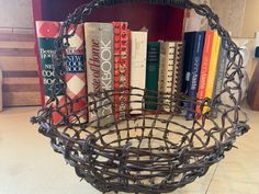 a wire basket filled with books on top of a counter