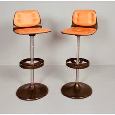 two orange stools sitting next to each other