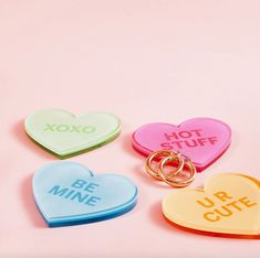 four heart shaped key chains with the words hot stuff, be mine and u - bye cute on them