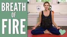 a woman is sitting on the floor with her hands in the air while doing yoga