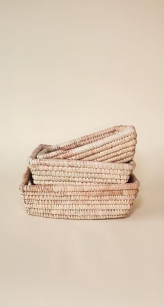 three wicker baskets stacked on top of each other