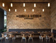 the inside of a restaurant with wooden tables and chairs, along with brick walls that read canalia bistroe