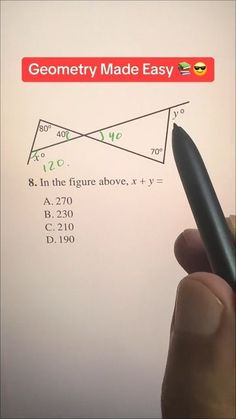 a hand is holding a pen in front of a piece of paper that has an image of two triangles on it