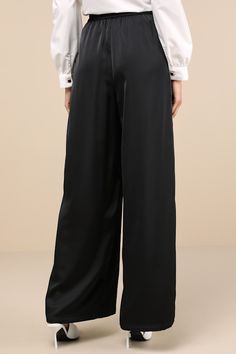 The Lulus Stunning Chicness Black Satin High-Rise Wide-Leg Pants will easily elevate any of your favorite fall 'fits! Sleek woven satin shapes these must-have pants that feature a high, banded waist (with elastic at the back for fit) and trendy, wide pant legs with pleated details, side seam pockets, and full-length hems. Hidden side zipper/clasp. Add a sweater and some boots and you'll instantly have a perfect ensemble! Fit: This garment fits true to size. Length: Floor length. Size medium Inse Sleek Silk Wide-leg Pants, Sleek Wide-leg Silk Pants, Sleek Silk High-waisted Wide Leg Pants, Sleek Silk Wide Leg Pants, Sleek Silk Trousers, Sleek Silk Straight Pants, Silk Wide Leg Pants With Elastic Waistband For Work, Sleek Satin Pants, Evening Straight Satin Pants