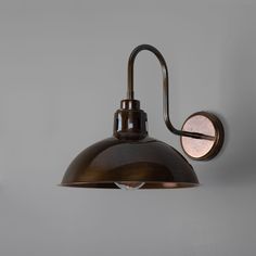 an industrial style wall light with a metal shade