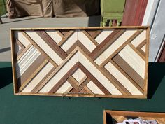 a wooden box sitting on top of a green table