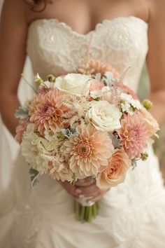 a bride holding a bouquet of flowers in her hands