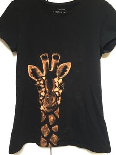 a black shirt with a giraffe on it