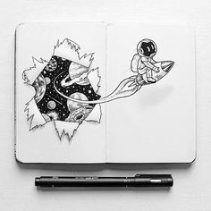 an open notebook with space drawings on it