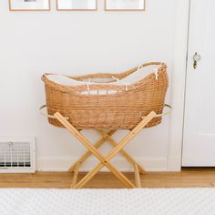 a wicker basket sitting on top of a wooden bench in front of a door