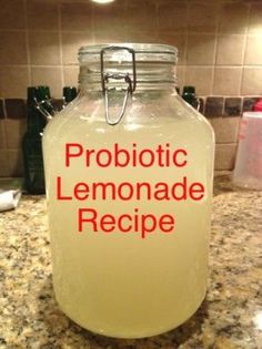 a glass jar filled with lemonade sitting on top of a counter