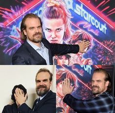 the actors are posing for pictures in front of a starcourt poster and one has his hands on his face