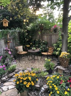 an outdoor patio with chairs, tables and flowers in the garden on graveled ground