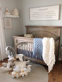 a baby's room with a crib, rocking horse and other toys on the floor