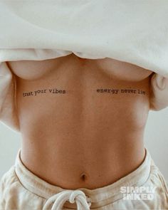 the back of a woman's stomach with two words written on her left side