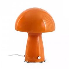 an orange mushroom shaped lamp on a white background