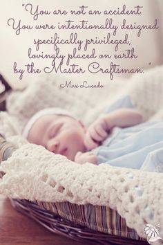 a baby laying in a basket on top of a table next to a quote that says, you are not an accident