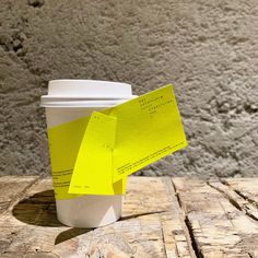 a coffee cup with yellow sticky notes on it