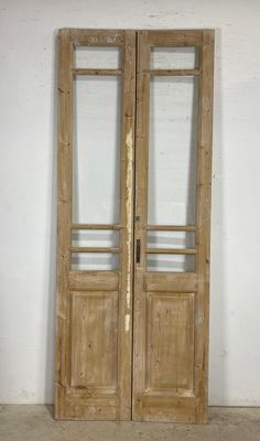 an old wooden double door with glass panels