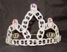 a tiara with pink and white stones on it