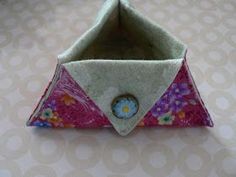 an origami flowered paper boat on a table