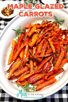 a white plate topped with carrots covered in marinade glazed carrots