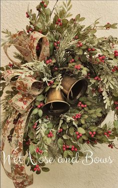 a christmas wreath with bells and greenery