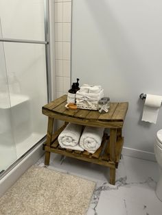 a wooden table with towels on it in a bathroom