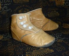 "Precious pair of antique Victorian BABY or large doll ~ high button shoes-boots.  These shoes are made of a soft ivory leather, and feature 4 white buttons along each side.   These are in nice vintage condition-there is some wear-I have not polished these cute shoes, I have cleaned the leather with Saphir Renovateur Conditioner.   Measurements~ 4 1/2\" long   2 1/2\" tall- 1 7/8\" wide measurements are taken on the outside of the shoes. Please check out the photos as this is part of the descrip Vintage Leather Booties, Vintage Beige Closed Toe Boots, Victorian Baby, Boots Cuir, Antique Fabrics, Crib Shoes, Shoes Booties, Vintage Shoes, Vintage Baby