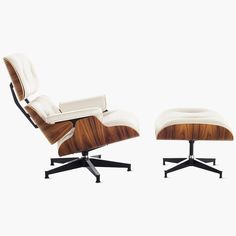 an eames lounge chair and ottoman with white leather upholstered on the back