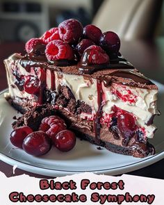 a piece of black forest cheesecake is on a plate with cherries and chocolate