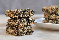 three cookies stacked on top of each other in front of a plate with one broken