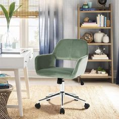 a green office chair sitting on top of a white desk in front of a window