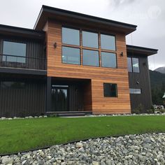 a large house with lots of windows and grass