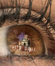 the reflection of a building in an eye