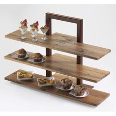 three tiered wooden tray with desserts on it