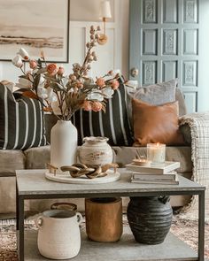 a living room filled with lots of furniture and flowers on top of a coffee table