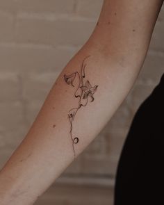 a woman's arm with a tattoo design on the left side of her arm